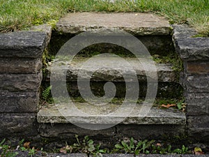 Short stairs  in quarrystone with weeds overgrown