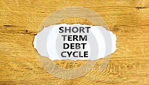 Short term debt cycle symbol. Concept words Short term debt cycle on beautiful white paper. Beautiful wooden background. Business