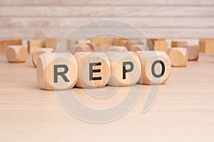 short word english text REPO on a wooden cubes with wooden background