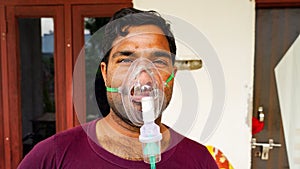 Shortage of vaccine Indian adult admitted in hospitals and taking Oxygen as a treatment of Covid 19. Infected man in panic