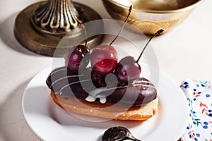 Shortbread cake with chocolate eclair a cherry