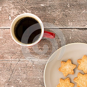 Shortbread Christmas Cookies and Coffee Mug on Brown Rustic Wood