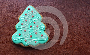 Shortbread Cookie In Pine Tree Shape With Colored Icing On A Leather Surface Concept Design For Greeting Card