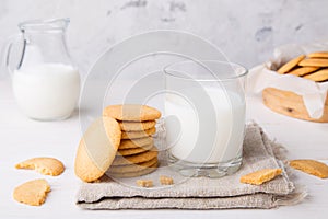 Shortbread kamut cookies with glass and jug of milk on napkin