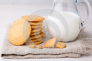 Shortbread kamut cookies with jug of milk on napkin