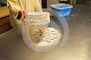 Shortcrust pastry cookies on a metal board. Icing sugar dusting
