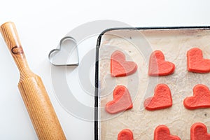 Shortcrust pastry with red dye for making cookies for Valentine's Day in the form of red hearts