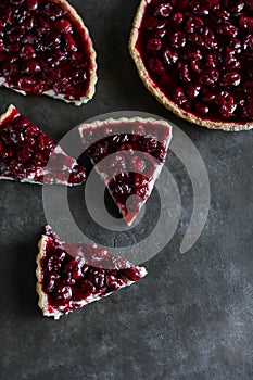 Shortcrust pastry tart with custard and cherry jelly.