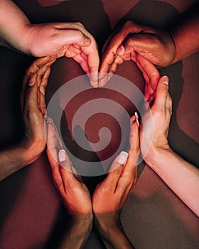 Shot from above of female hands making a big heart shape