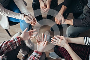 Shot from above of people`s hands during psychoterapy group session