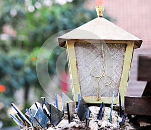 Shot from afar by 200mm zoom lens is a gate light rule of thirds blurry background florescent glass shade curved square framed photo