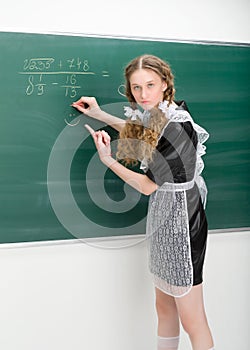Shot of angry school girl standing at blackboard