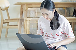 Shot of Asian girl school student e learning distance training course study work at home