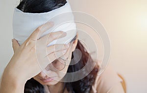 Shot of Asian woman with trauma of the head and wrapped bandages around her head