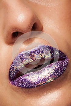 Shot of beautiful girl with purple lipstick and silver glitter