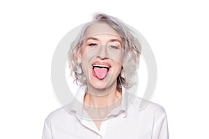 Shot of a beautiful mature woman having fun and teasing sticking out her tongue isolated on white background