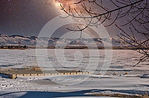 Shot of a beautiful sky full of stars of the Milky Way galaxy in the winter snowy night.