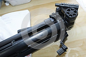 Tripod on angle Shot lay on a Decorated brown Table After using on Table Top works