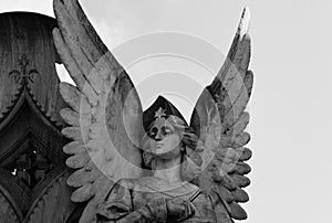 Elegant angel next to the cross photo