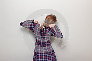 Shot of blond young woman stretching hands, looking relaxed, back view