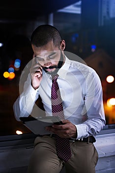 Shot of a businessman talking on his cellphone late at night. Real life businesspeople shot on location. Since these