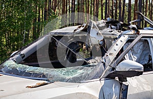 Shot car during the war in Ukraine. A car of civilians with shrapnel holes from explosions. Car accident. Car graveyard. Traces of