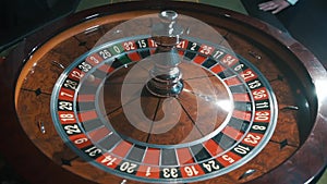 A shot of a casino roulette in motion,the ball stops at 12 red thirty six/Better luck next time