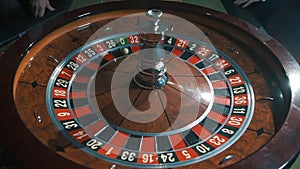 A shot of a casino roulette in motion, the ball stops at 26 black thirty six/Better luck next time