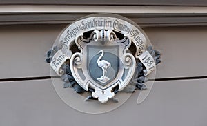 shield and arms with ostrich holding a horseshoe photo