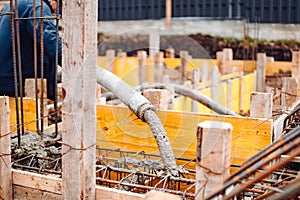 shot of concrete casting on reinforcing metal bars of floor in industrial construction site