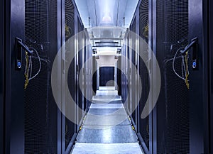 Shot of Corridor in Working Data Center Full of Rack Servers and Supercomputers. concept of big data storage and cloud