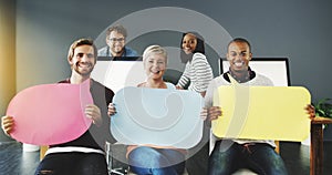 Weve got a message from the team. Shot of a diverse group of people holding up speech bubbles in a modern office.