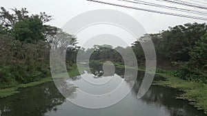 Shot of drone crossing a bridge underneath a swamp