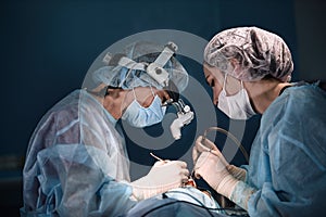 A shot of an emergency and a serious accident in the operating room, a team of surgeons makes an emergency operation to