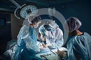 A shot of an emergency and a serious accident in the operating room, a team of surgeons makes an emergency operation to