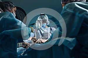 A shot of an emergency and a serious accident in the operating room, a team of surgeons makes an emergency operation to