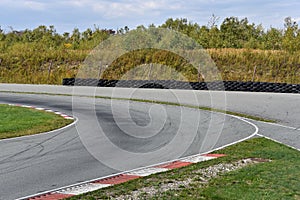 Shot of empty auto racing racetrack turn. Motor racing track. Turning asphalt road with marking lines