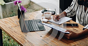 shot of female accounting bookkeeper providing accounting service for small businesses, woman using digital tablet and