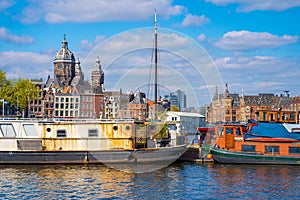 Shot of fishing vessels on the background of the Basilica of Saint Nicholas in Amsterdam