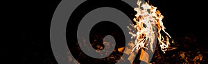 Shot of flame and logs in camp fire in darkness in the night