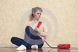 Shot of focused sad young woman deciding to call or not to call