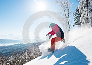 Shot of a freeride snowboarder riding in the mountains wearing snowboarding gear