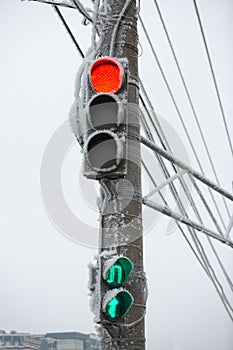 Shot of a frozen red traffic light with blue sky and electrical wires in background. Increase in the number of accidents
