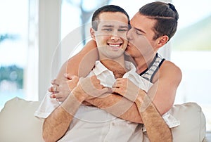 Life together is always special. Shot of a gay couple relaxing together at home.