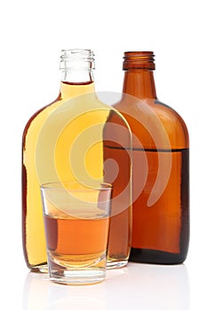 Shot glass and pocket bottle of whiskey