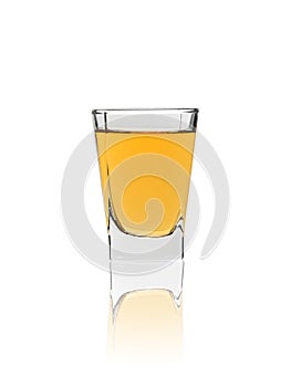 Shot glass of whiskey isolated on white background with reflection