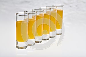 Tall Shot Glasses with orange flavoured Alcoholic shots photo