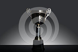 Shot of gold award trophy in gray background