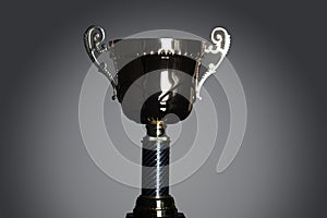 Shot of gold award trophy in gray background