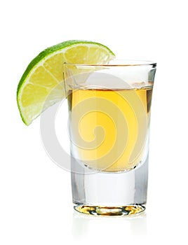 Shot of gold tequila with lime slice